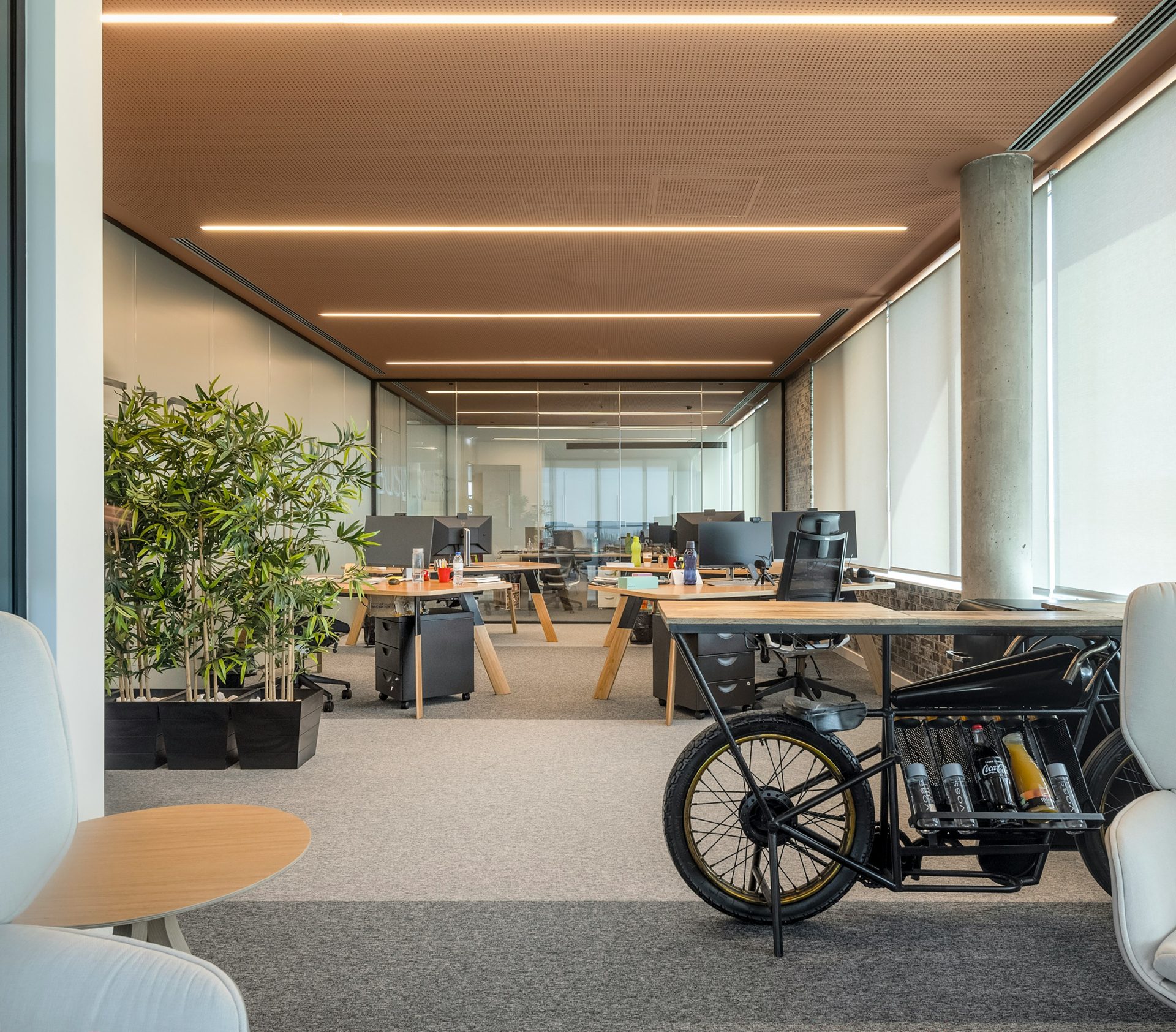 an office with a bike parked in the middle of the room