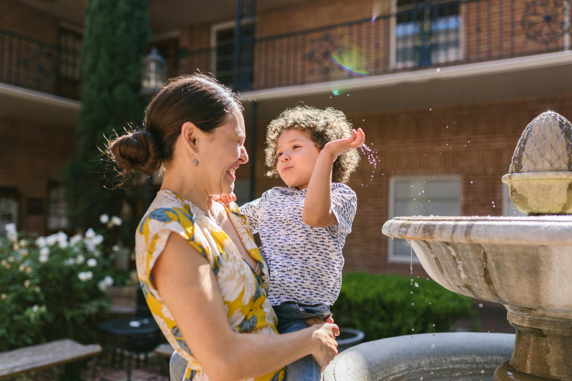 Son Splashing Water from the Fountain on His Mother